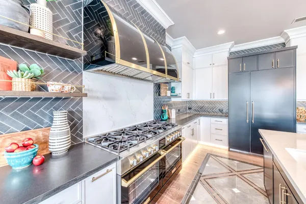 a kitchen with stainless steel appliances granite countertop a stove and a cabinets