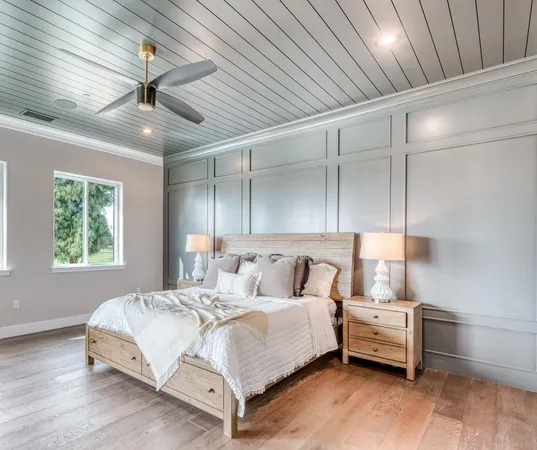 a bedroom with a bed and a ceiling fan