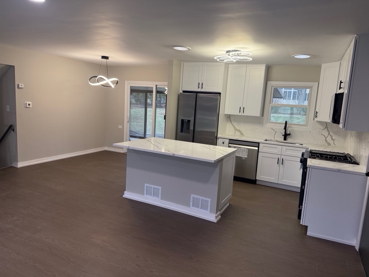 126 Rosedale Court Bloomingdale, IL 60108 - Photo 6 of 26 a large kitchen with stainless steel appliances a sink dishwasher a refrigerator and a stove with wooden floor