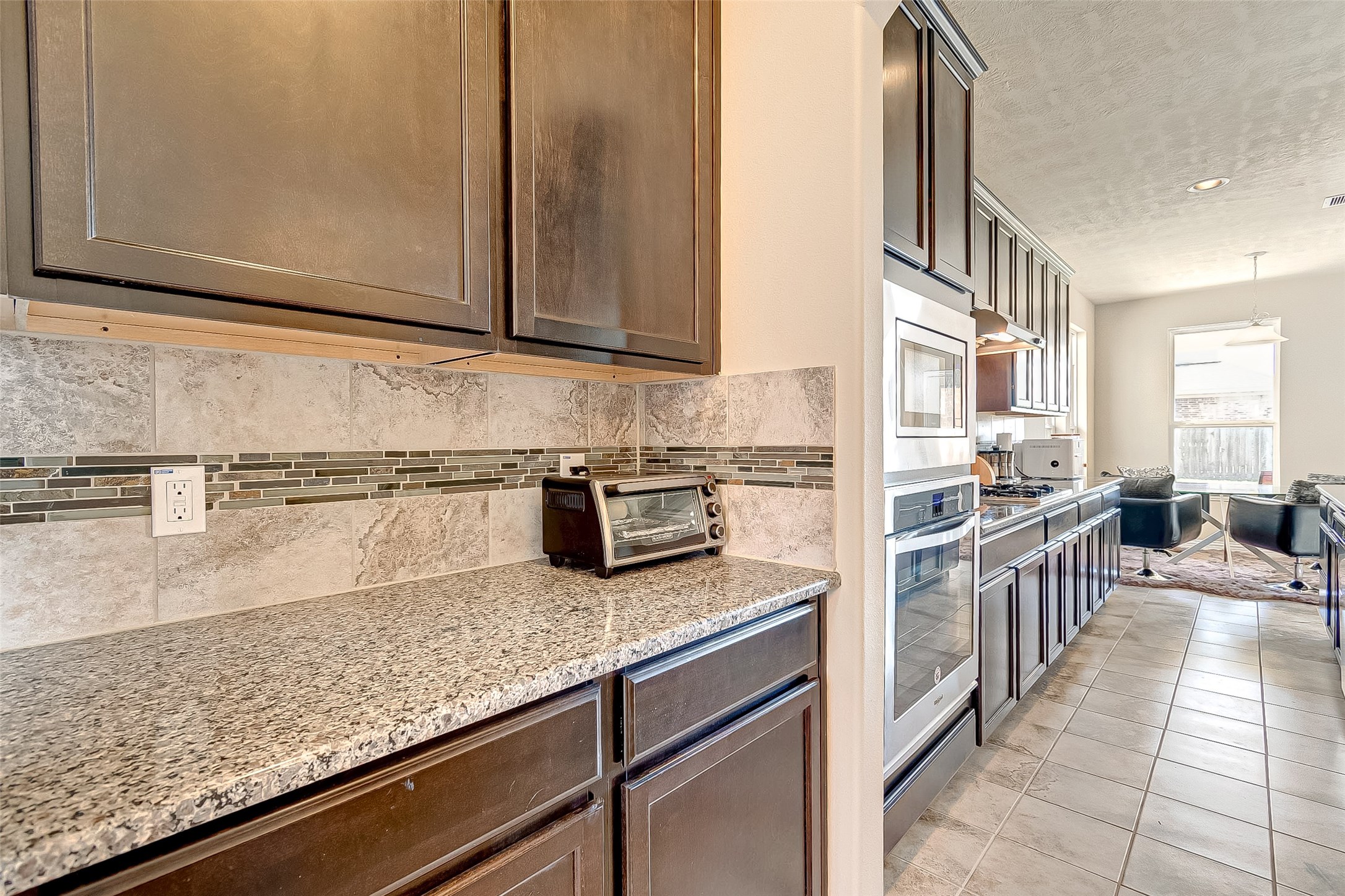 907 River Delta Lane Rosenberg, TX 77469 - Photo 16 of 49 a kitchen with stainless steel appliances granite countertop a sink stove and cabinets