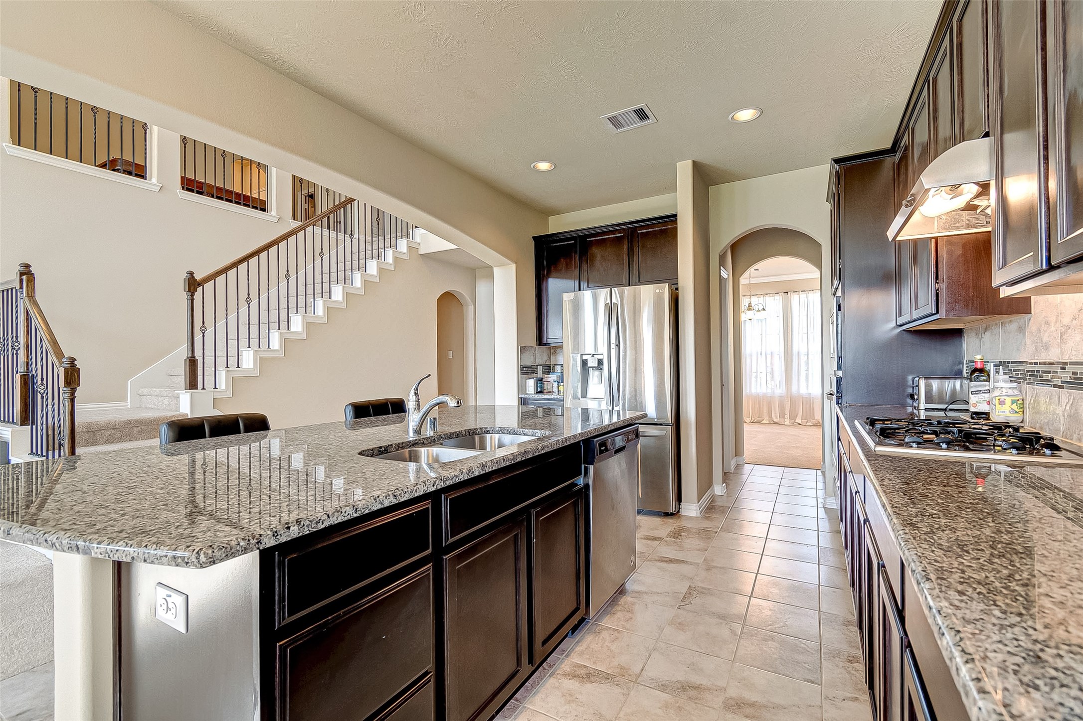907 River Delta Lane Rosenberg, TX 77469 - Photo 19 of 49 a large kitchen with stainless steel appliances granite countertop a sink and a counter top space