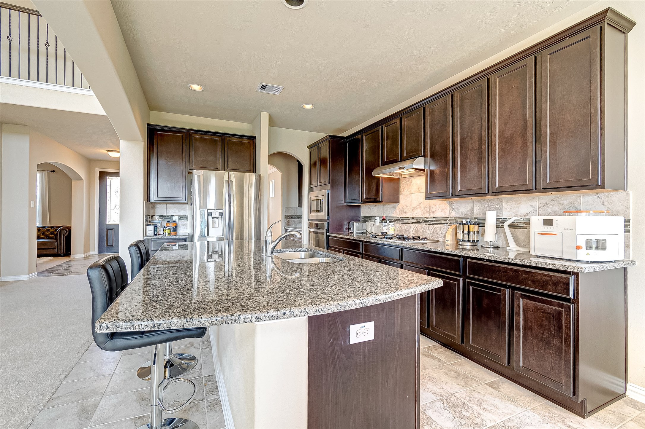 907 River Delta Lane Rosenberg, TX 77469 - Photo 20 of 49 a kitchen with stainless steel appliances granite countertop a stove top oven a sink refrigerator and cabinets