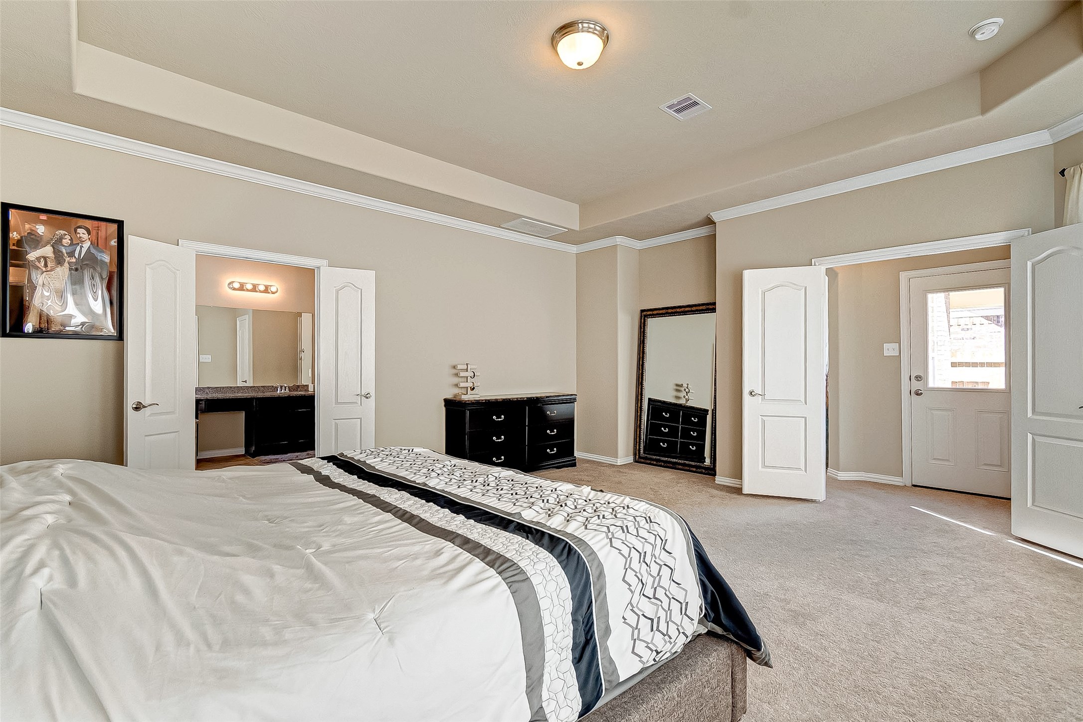 907 River Delta Lane Rosenberg, TX 77469 - Photo 28 of 49 a bedroom with a large bed and a fireplace