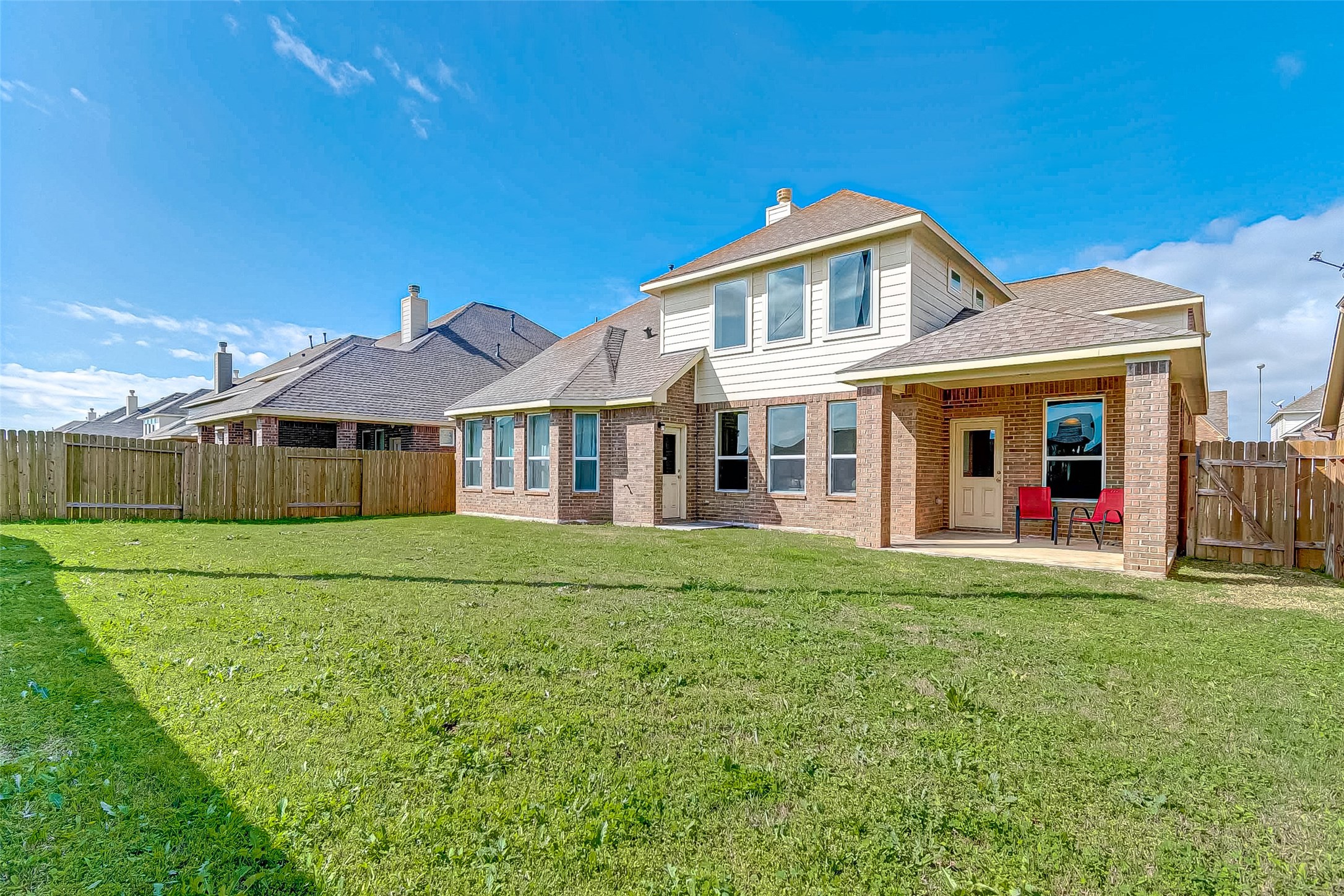 907 River Delta Lane Rosenberg, TX 77469 - Photo 46 of 49 a front view of a house with a yard and trees