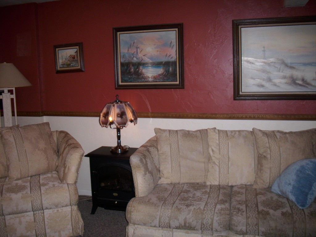 902 Irving Road, Unit 902 Randolph, MA 02368 - Photo 15 of 15 a living room with furniture and a painting on the wall