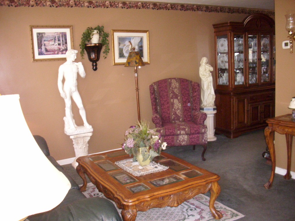 902 Irving Road, Unit 902 Randolph, MA 02368 - Photo 4 of 15 a living room with furniture and wooden floor