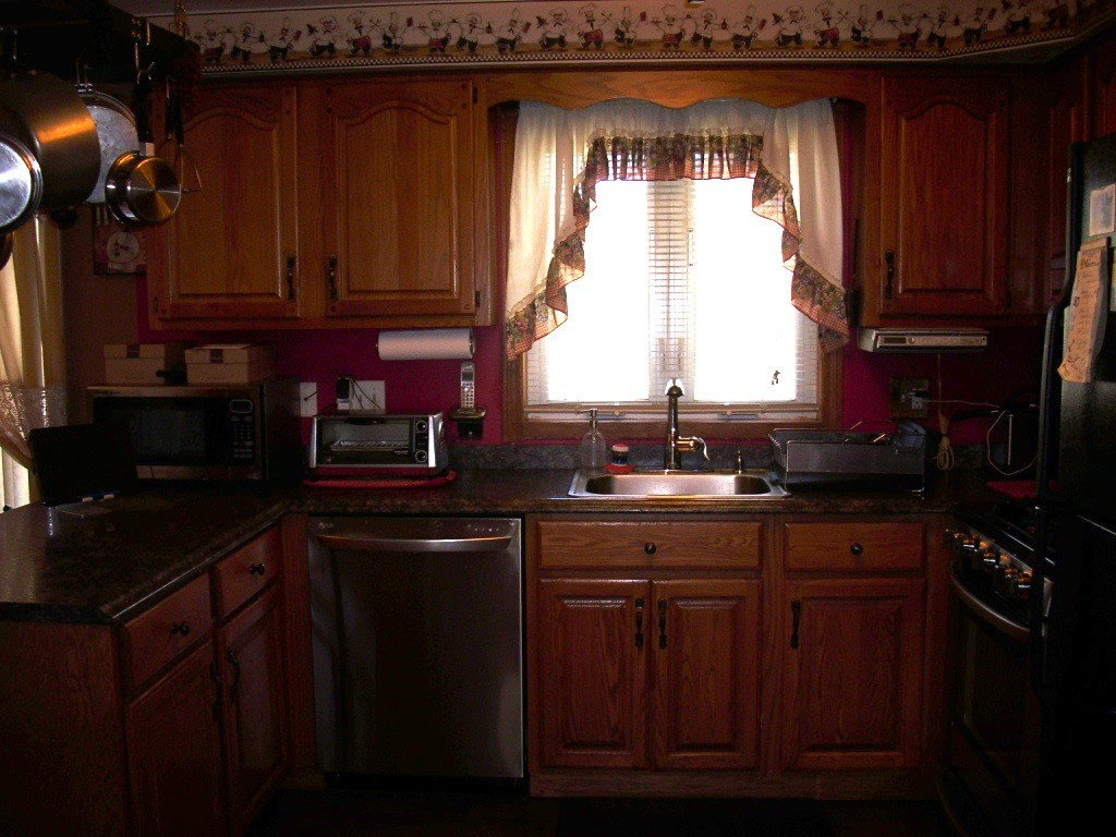 902 Irving Road, Unit 902 Randolph, MA 02368 - Photo 7 of 15 a kitchen with a sink a window and cabinets