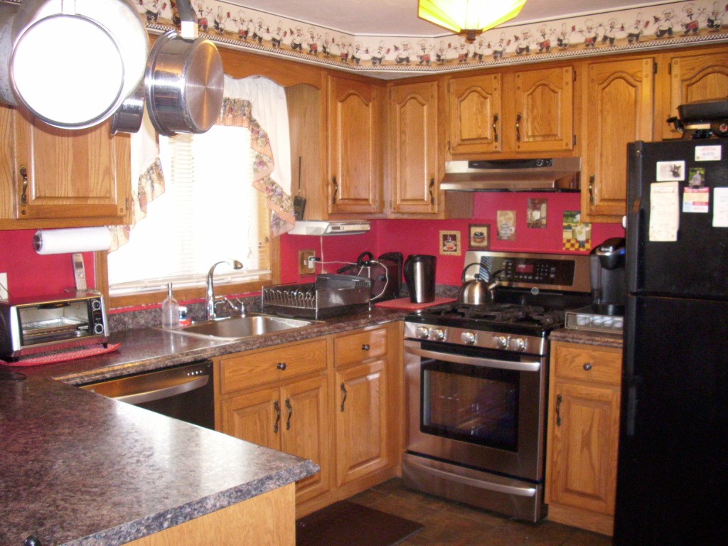 902 Irving Road, Unit 902 Randolph, MA 02368 - Photo 8 of 15 a kitchen with stainless steel appliances granite countertop a stove a sink and a microwave