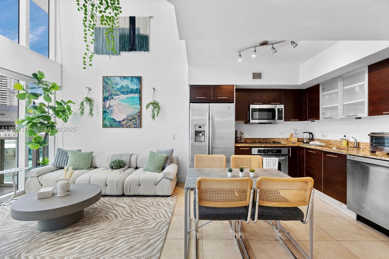 41 Southeast 5th Street, Unit 510 Miami, FL 33131 - Photo 11 of 38 a living room with furniture and a wooden floor