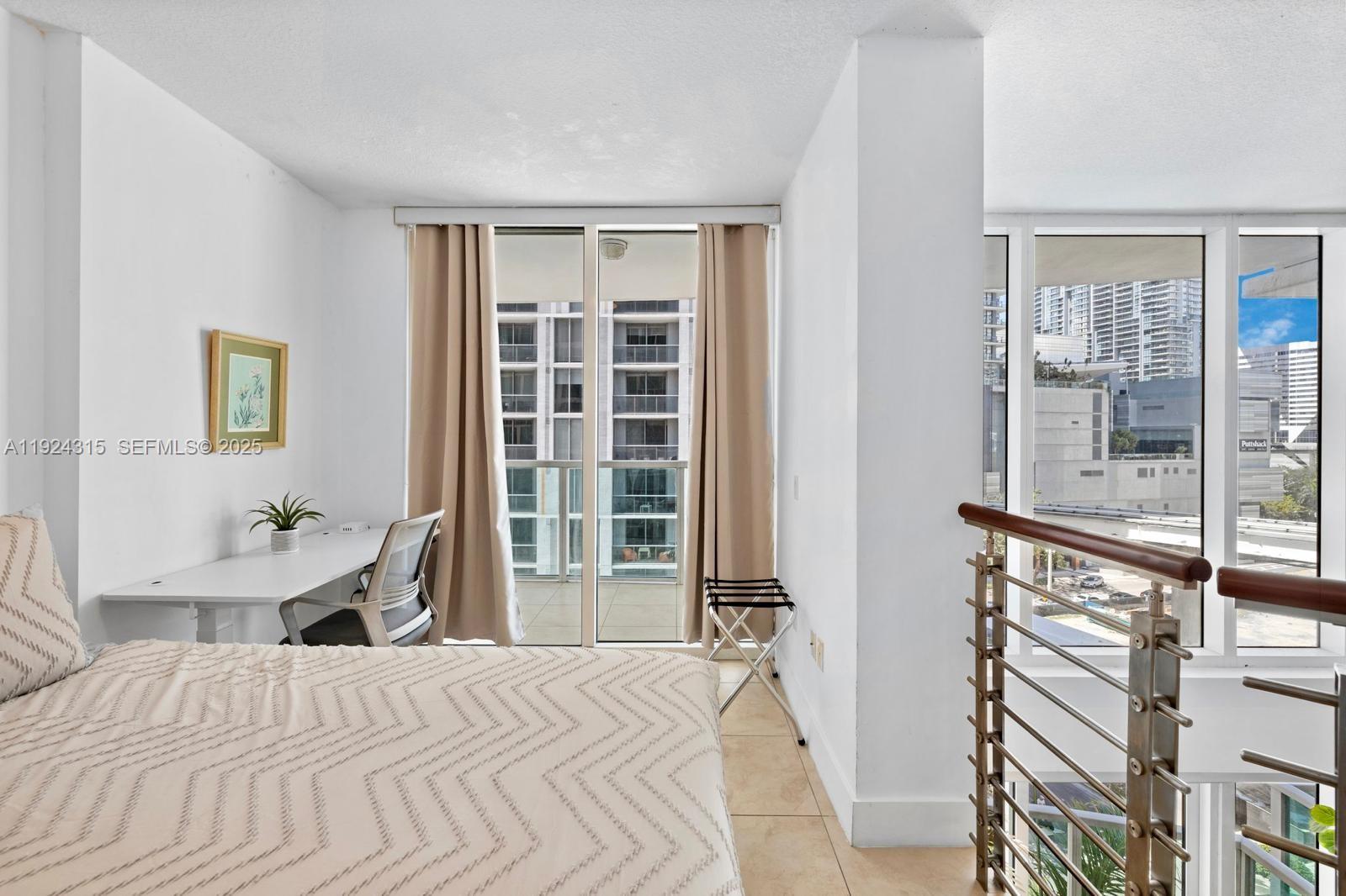 41 Southeast 5th Street, Unit 510 Miami, FL 33131 - Photo 20 of 38 a bedroom with a bed and a window