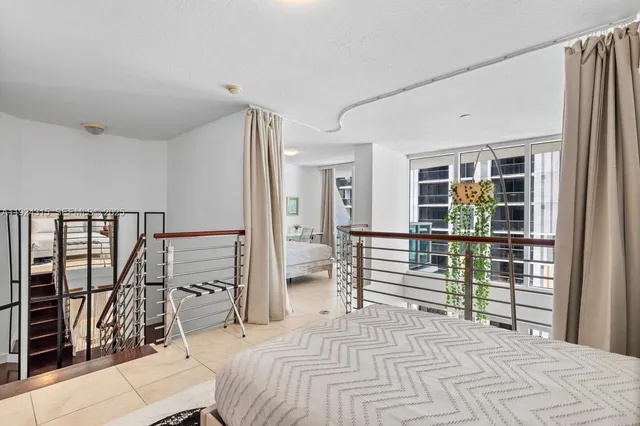 a bedroom with a bed and a view of walk in closet