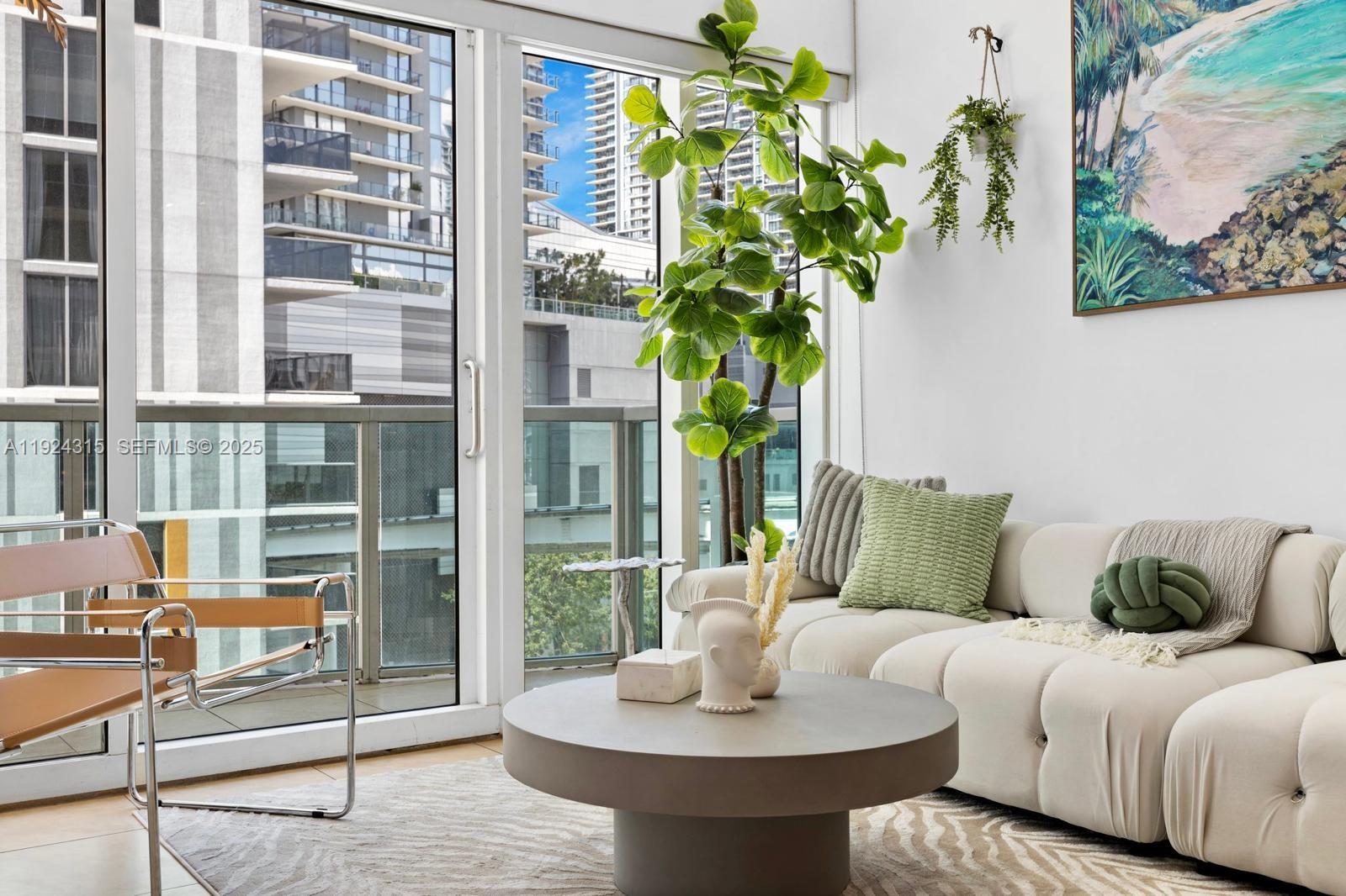 41 Southeast 5th Street, Unit 510 Miami, FL 33131 - Photo 3 of 38 a living room with furniture and a potted plant