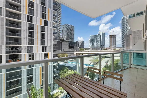 a balcony with table and chairs