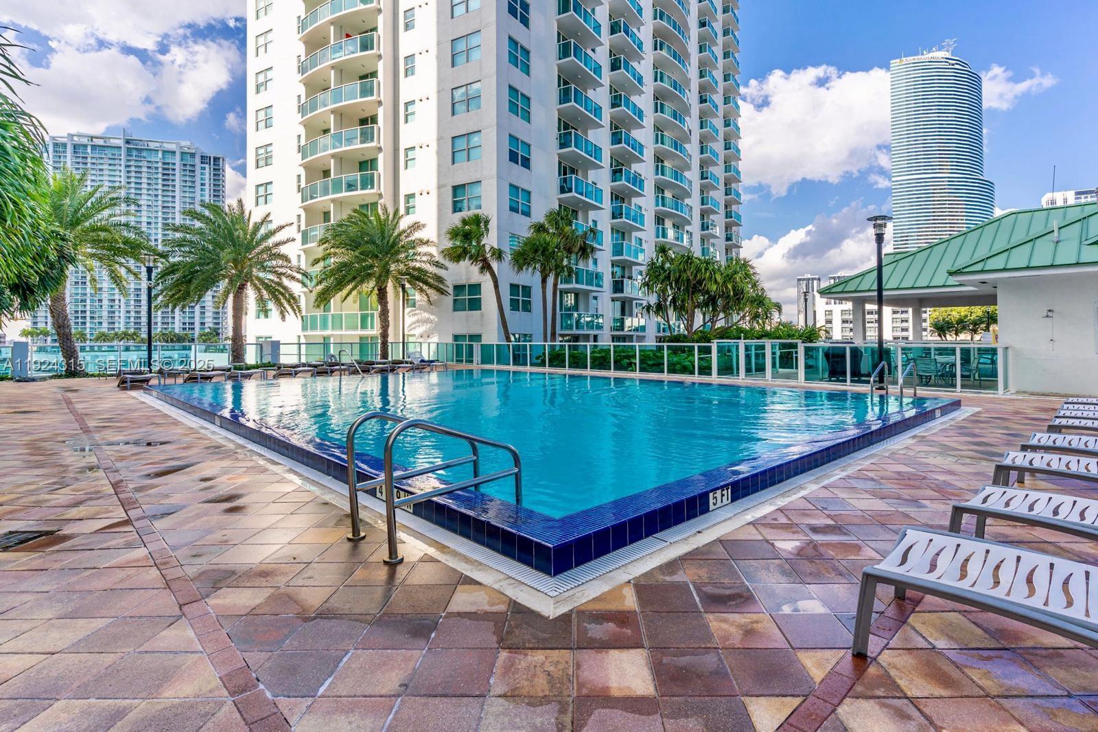 41 Southeast 5th Street, Unit 510 Miami, FL 33131 - Photo 36 of 38 a view of a swimming pool with a patio