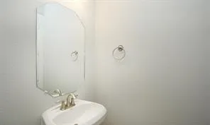 a bathroom with a sink a mirror and vanity