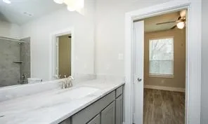 a bathroom with a granite countertop sink and a mirror