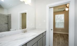 1905 Lonestar Brook Lane Houston, TX 77080 - Photo 14 of 23 a bathroom with a granite countertop sink and a mirror