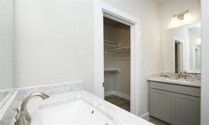 1905 Lonestar Brook Lane Houston, TX 77080 - Photo 21 of 23 a bathroom with a tub sink and mirror
