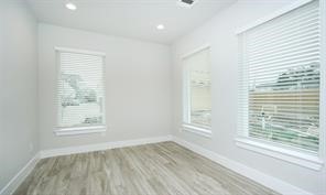 1905 Lonestar Brook Lane Houston, TX 77080 - Photo 4 of 23 a view of an empty room with wooden floor and a window