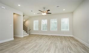 1905 Lonestar Brook Lane Houston, TX 77080 - Photo 6 of 23 a view of an empty room with a window and wooden floor