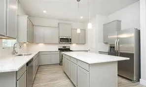 a kitchen with stainless steel appliances a sink stove and cabinets