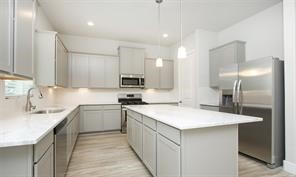 1905 Lonestar Brook Lane Houston, TX 77080 - Photo 10 of 23 a kitchen with stainless steel appliances a sink stove and cabinets