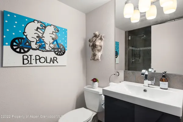 a bathroom with a sink mirror and vanity