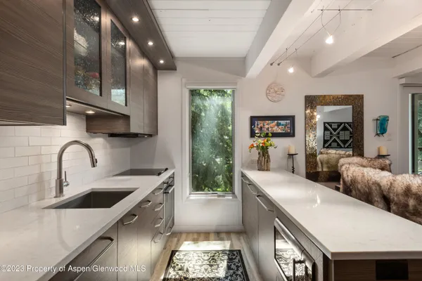 a large kitchen with stainless steel appliances granite countertop a lot of counter space and a sink