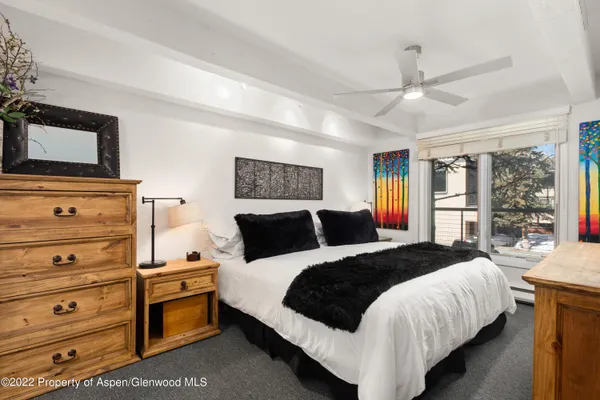 a bedroom with bed and a window