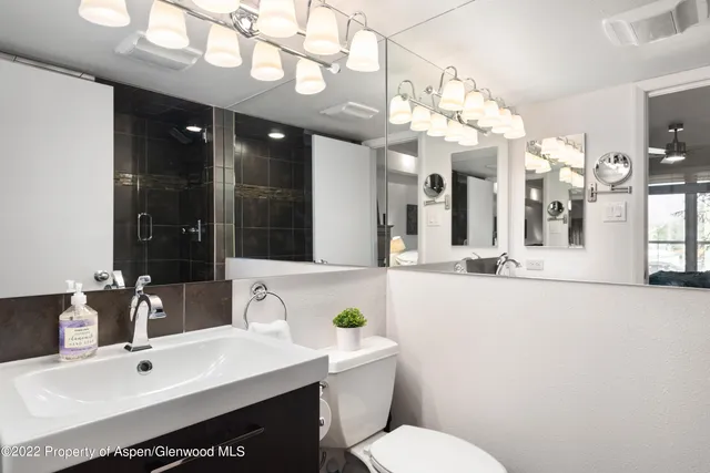 a bathroom with a sink vanity granite and a mirror