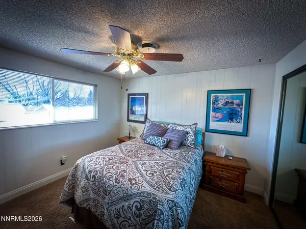 a spacious bedroom with a bed and a chandelier