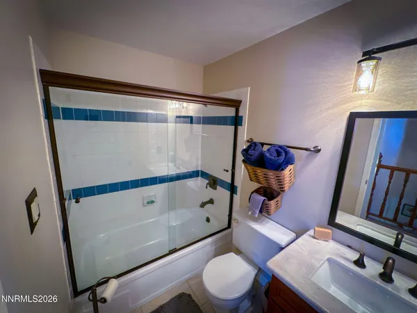 a bathroom with a toilet and a mirror