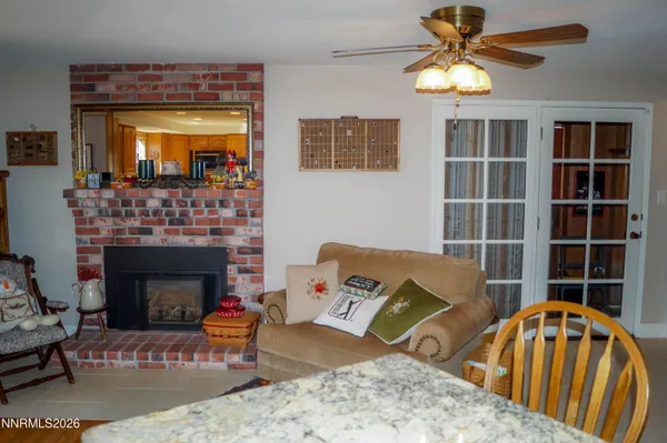 a living room with furniture fireplace and window