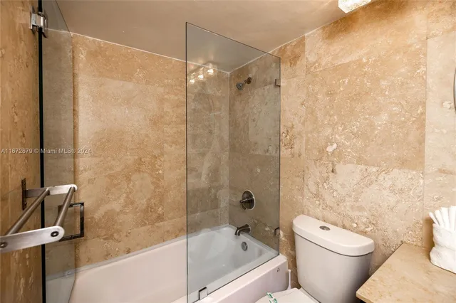 a bathroom with a shower and a toilet