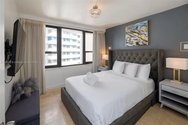 a bedroom with a bed and a couch