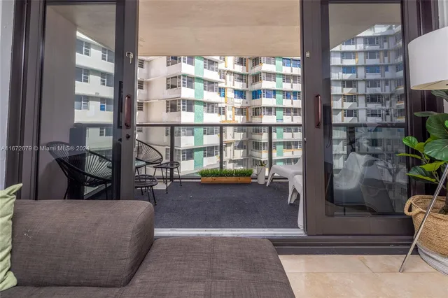 a living room with furniture and a floor to ceiling window