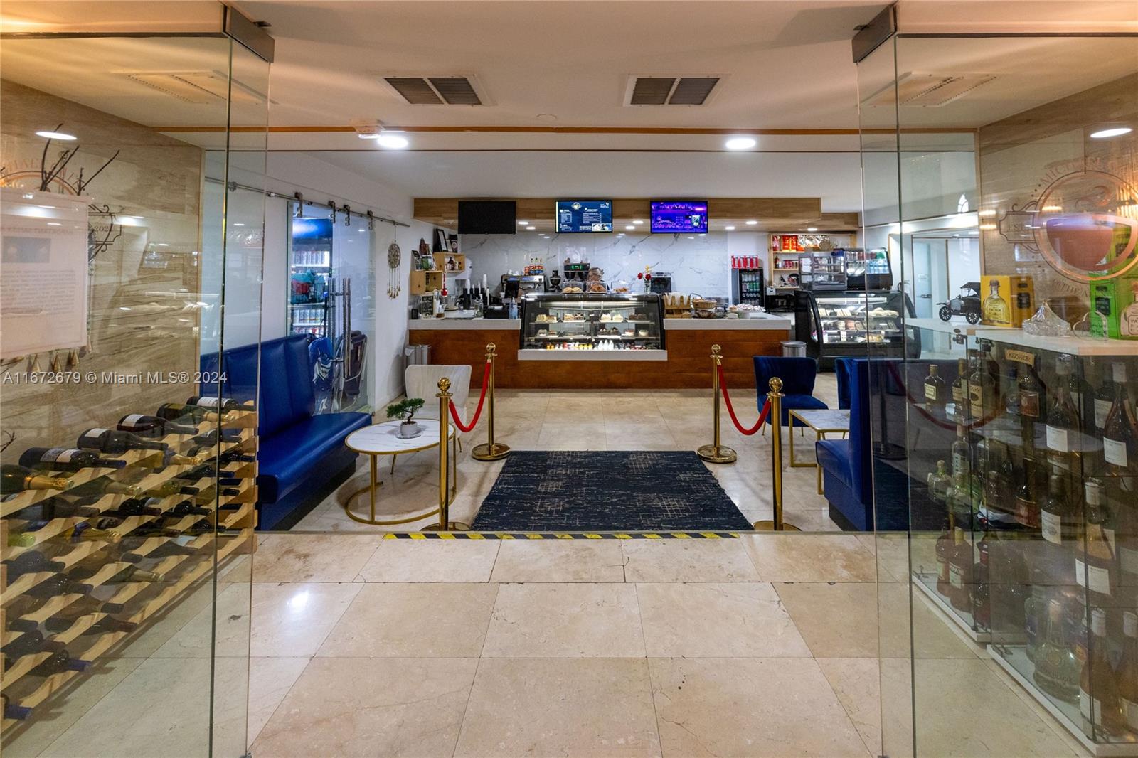 5225 Collins Avenue, Unit 1114 Miami Beach, FL 33140 - Photo 29 of 49 a living room with lots of furniture and kitchen view