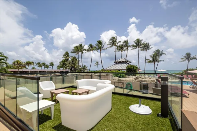 a view of a swimming pool with outdoor seating