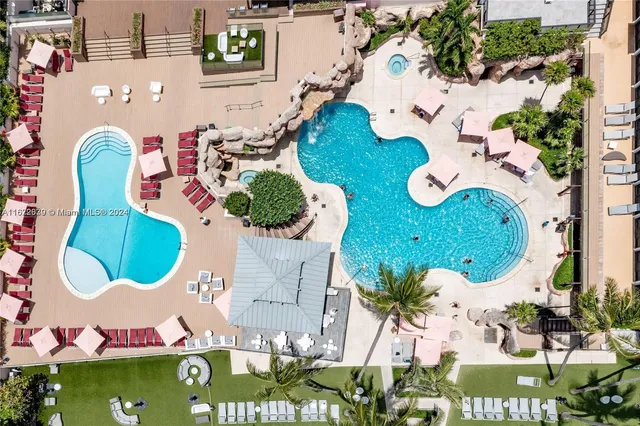a view of a swimming pool with lounge chairs