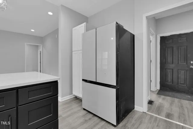 a kitchen with white cabinets stainless steel appliances and sink