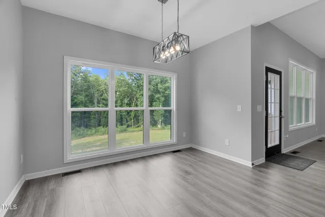an empty room with closet and a window