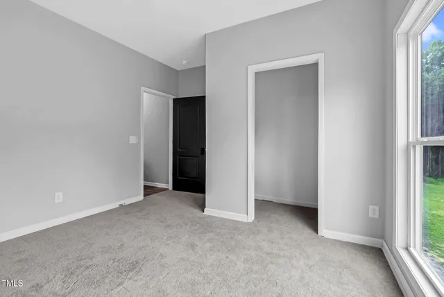 a room with a bed and window