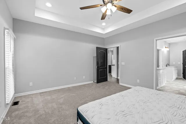 a white toilet sitting next to a white cabinet