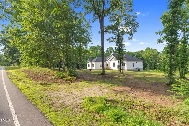 a view of a house with pool and trees