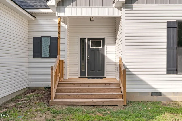 a view of an entryway with wooden floor