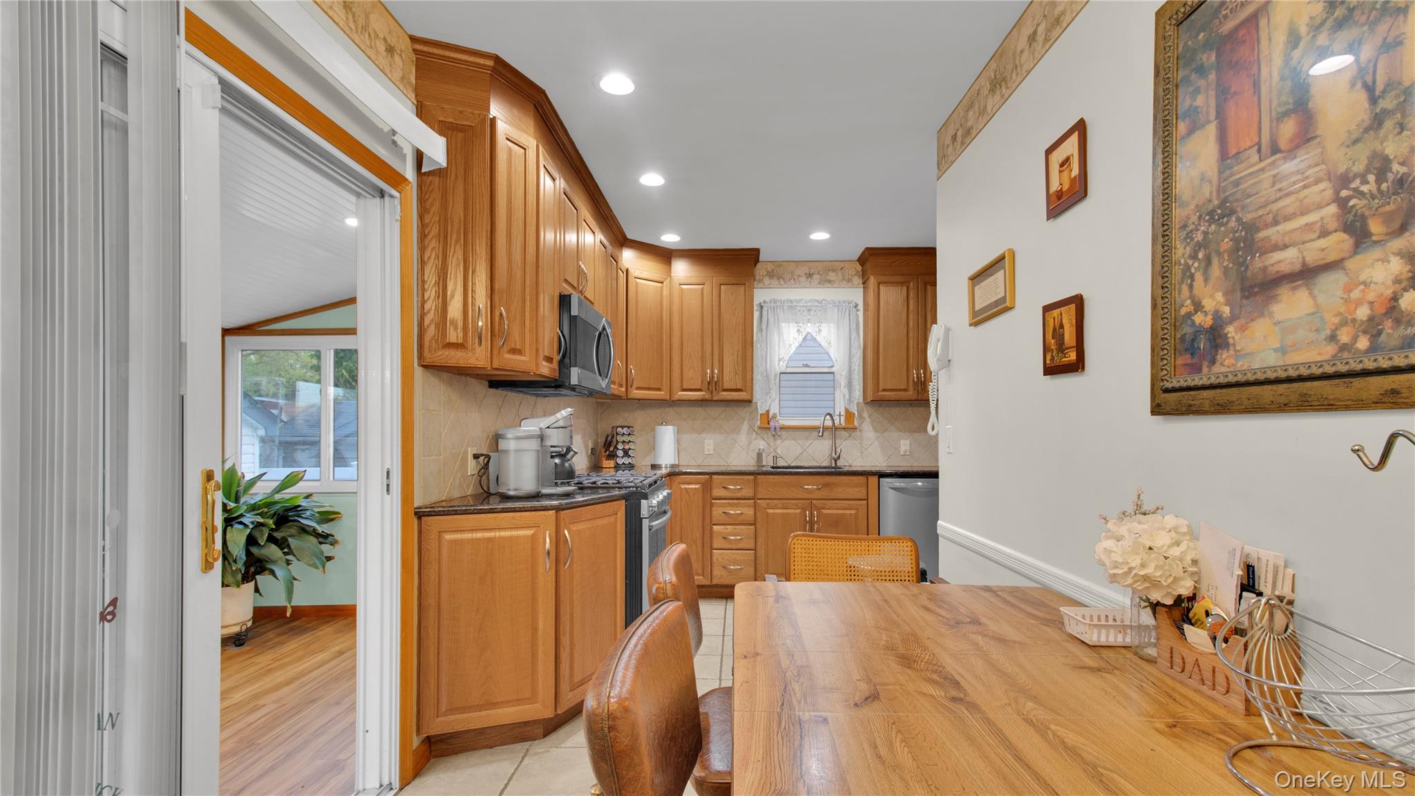 56 Liggett Road Valley Stream, NY 11581 - Photo 14 of 29 a kitchen with stainless steel appliances granite countertop a refrigerator a sink a stove and a wooden cabinets