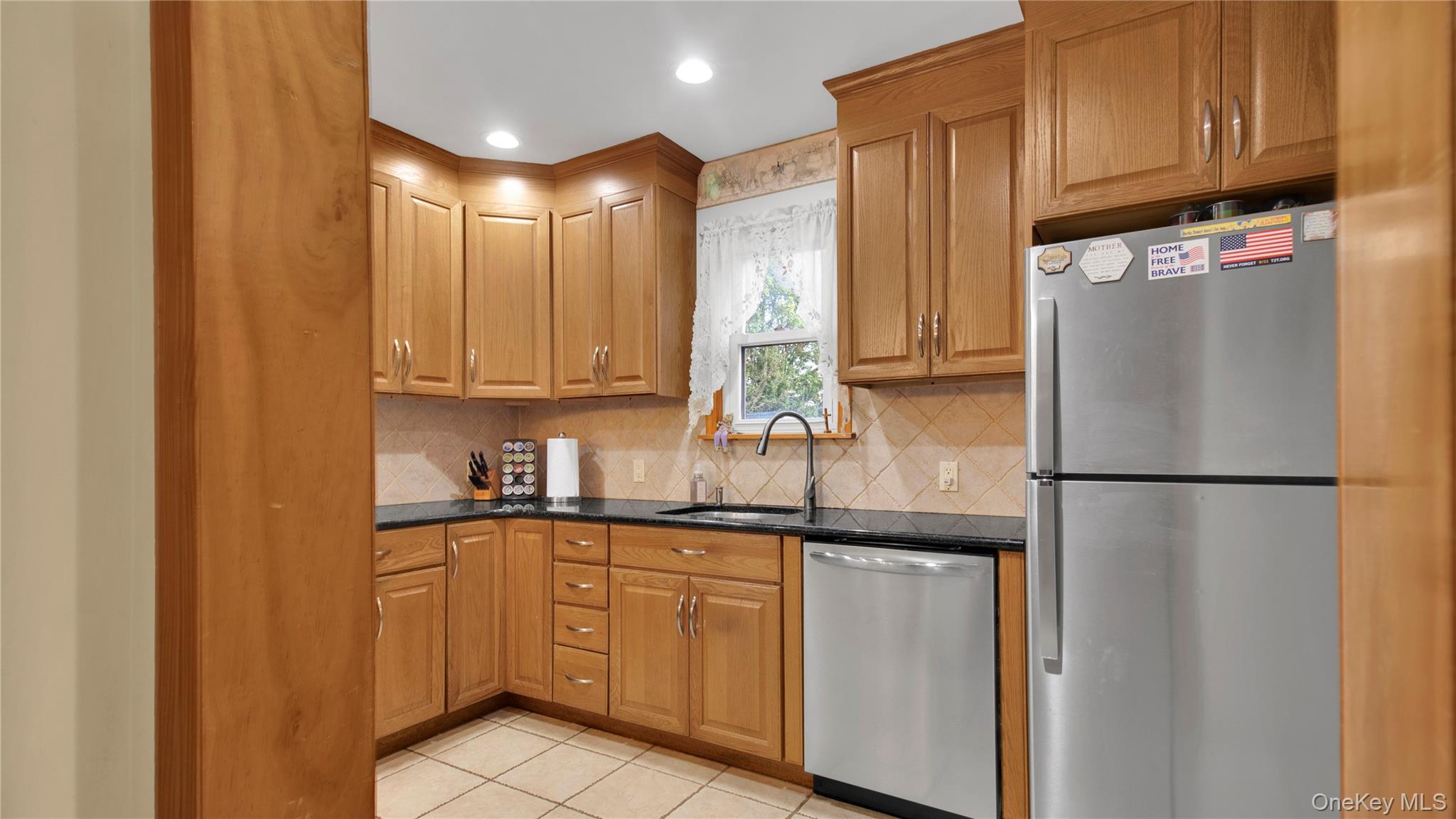 56 Liggett Road Valley Stream, NY 11581 - Photo 15 of 29 a kitchen with stainless steel appliances granite countertop a refrigerator a sink and cabinets
