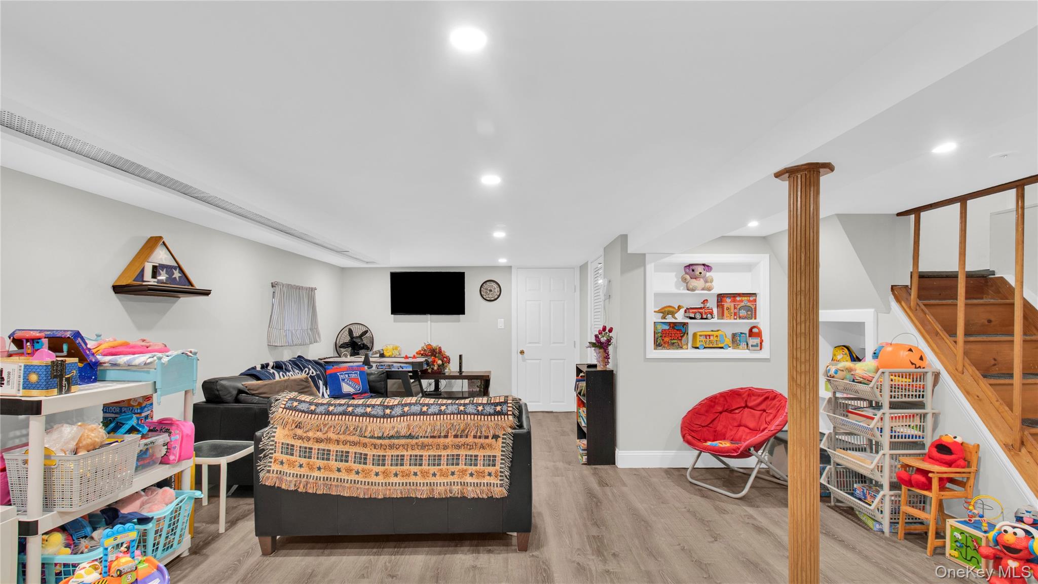 56 Liggett Road Valley Stream, NY 11581 - Photo 19 of 29 a living room with furniture and a flat screen tv