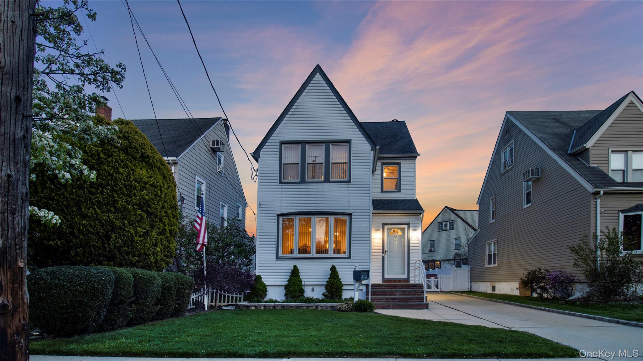 56 Liggett Road Valley Stream, NY 11581 - Photo 2 of 29 a front view of a house with garden