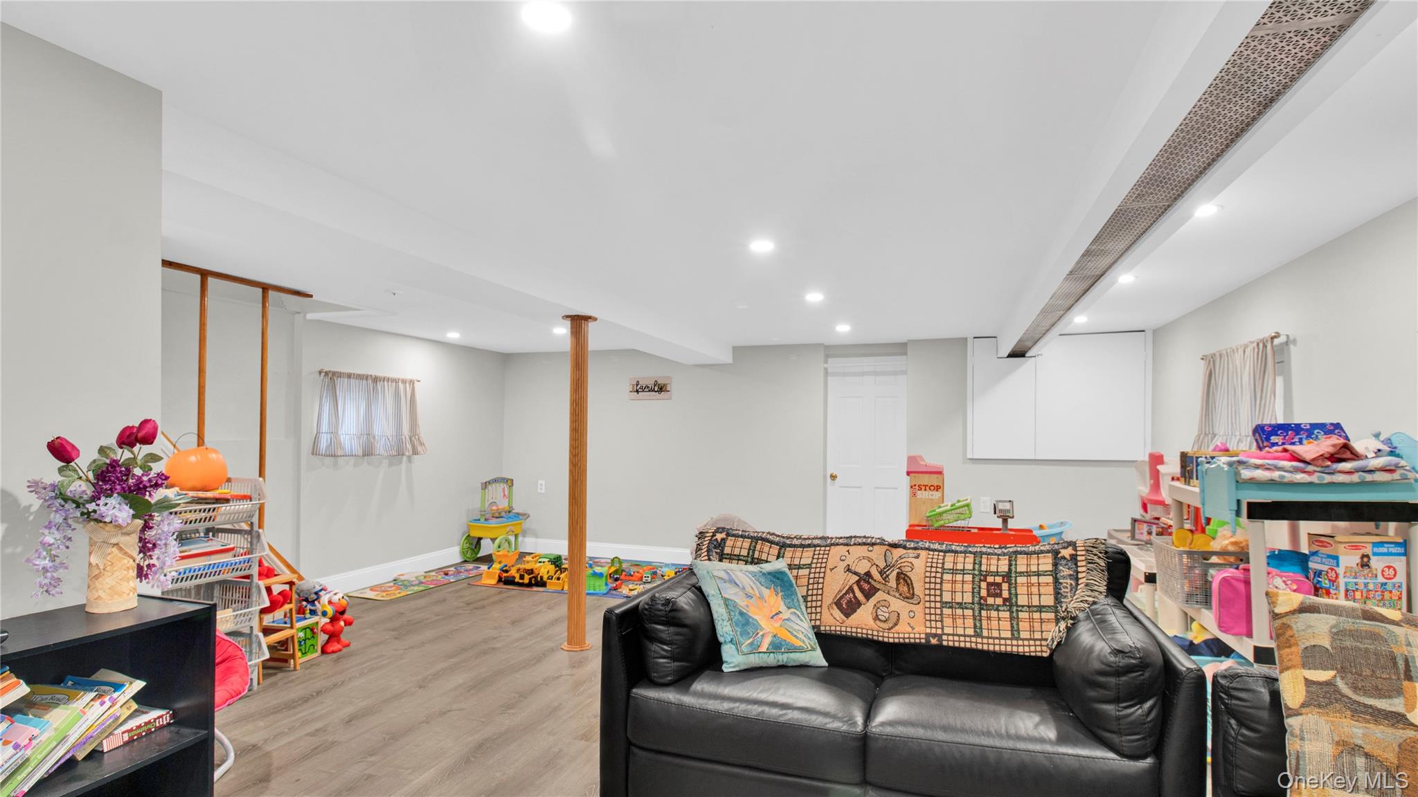 56 Liggett Road Valley Stream, NY 11581 - Photo 21 of 29 a living room with furniture and a couch